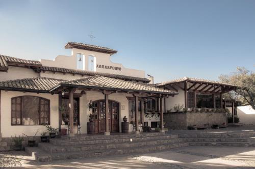 an old building with a store on a street at Hotel Hacienda Abraspungo in Riobamba