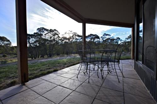 a patio with chairs and a table on a porch at Snowy Wilderness in Ingebyra
