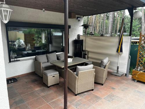a patio with a table and chairs on a patio at Kiefernblick in Plötzky