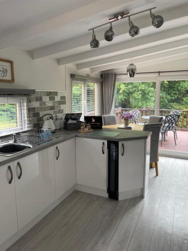 a kitchen with white cabinets and a counter top at Lakeview Lodge, Builth Wells (pet friendly) in Builth Wells