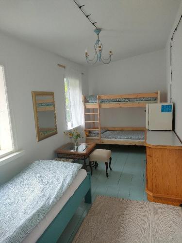 a bedroom with two bunk beds and a chandelier at Willa Gaszek in Inowłódz