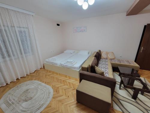 a living room with a bed and a couch at Stavrov Apartment in Negotino