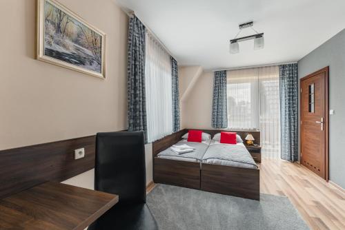 a bedroom with a bed with red pillows on it at Magdalenka 5 min pieszo od Kotelnicy in Białka Tatrzanska