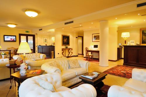 a large living room with white couches and a table at Villa Cattani Stuart XVII secolo in Pesaro