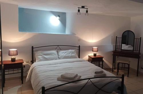 a bedroom with a bed with towels on it at VIEW OF CASTLE in Monemvasia