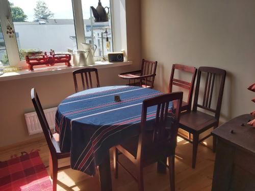 comedor con mesa azul y sillas en Perepuhkus Apartment, en Pärnu