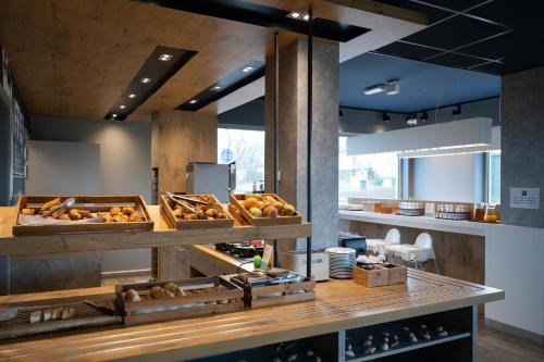 a bakery with breads and other items on a counter at ibis budget Oostende Airport in Ostend