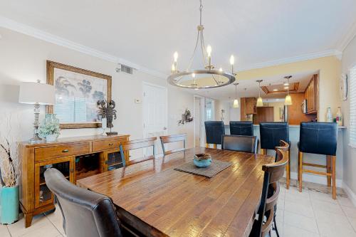 a dining room and kitchen with a wooden table and chairs at Water View 402 in Clearwater Beach
