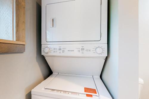 a white refrigerator with a washer and dryer at Our Barn in Marlboro