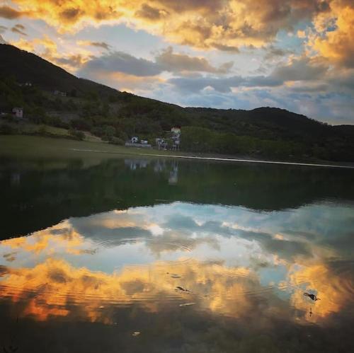 a large body of water with a cloudy sky at Casa sul lago Nonna Gio' in Colle di Tora