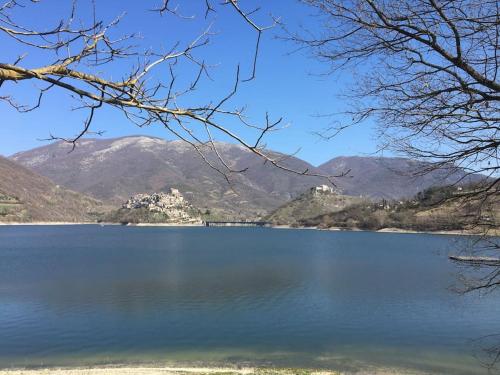 a view of a lake with mountains in the background at Casa sul lago Nonna Gio' in Colle di Tora