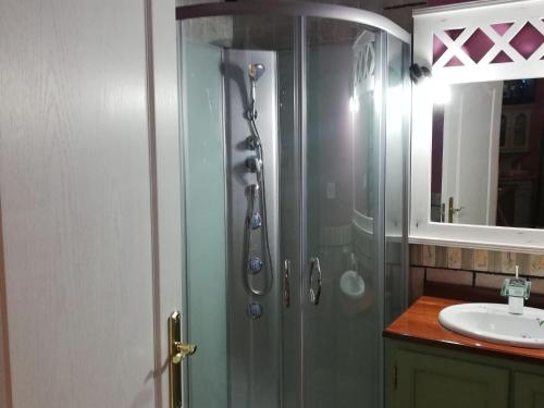 a shower with a glass door next to a sink at Vibrant holiday home in Villanueva with terrace in Villanueva