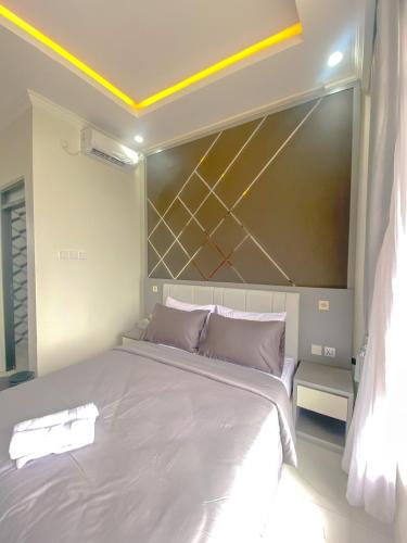 Postel nebo postele na pokoji v ubytování Algara Puncak Hotel