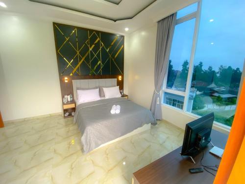 Postel nebo postele na pokoji v ubytování Algara Puncak Hotel