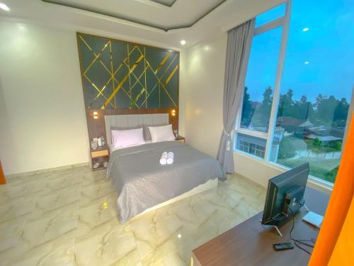 Postel nebo postele na pokoji v ubytování Algara Puncak Hotel