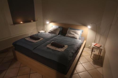 a bedroom with a large bed with blue sheets and pillows at Villa apartment Hafnarfjordur - Ideal for Aurora in Hafnarfjördur