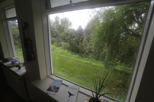 a window with a view of a green field at Villa apartment Hafnarfjordur - Ideal for Aurora in Hafnarfjördur