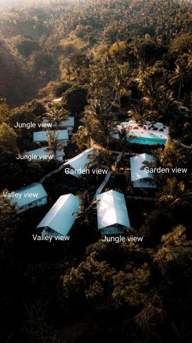 a group of tents in a field with trees at Autentik Penida "Glamping" - Adults only in Nusa Penida