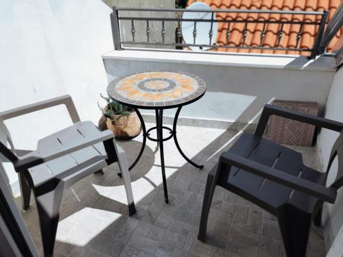 a table and two chairs and a table and chairs at Falcons Nest in Šibenik