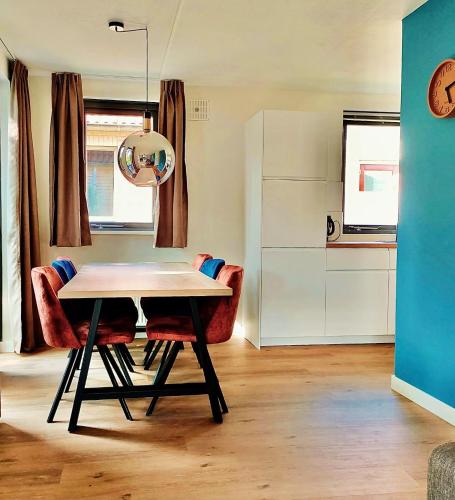 a dining room table and chairs in a room at Green Hills home in Ewijk