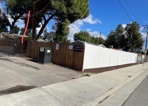 a wooden fence with a white picket fence at RV3 Wonderfull RV in MOVAL private freeparking Netflix in Moreno Valley