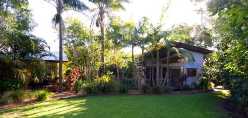 a house with a lawn in front of it at Mobys Beachside Retreat in Boomerang Beach
