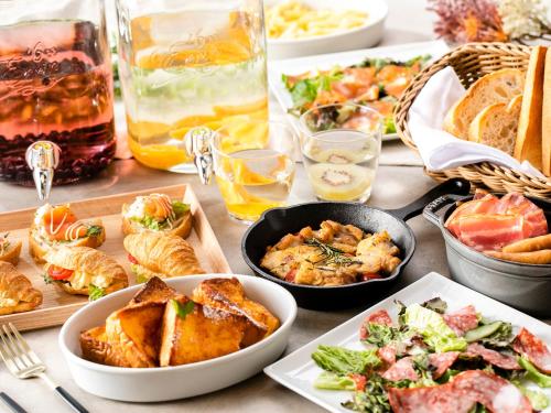 a table with many plates of food and drinks at Hotel Gracery Kyoto Sanjo in Kyoto