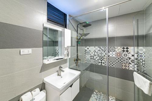 a bathroom with a toilet and a sink and a shower at Nostalgia Hotel and Spa in Hoi An