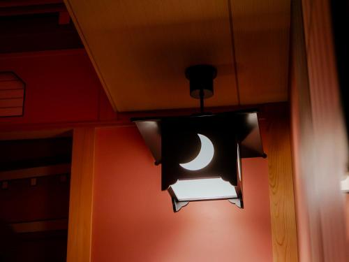 a light hanging from a ceiling with a moon at Hotel Gracery Kyoto Sanjo in Kyoto