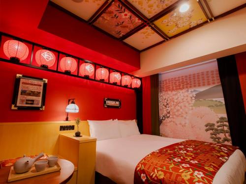 a hotel room with a bed and red walls at Hotel Gracery Kyoto Sanjo in Kyoto