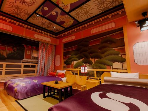 a bedroom with a bed and a table and chairs at Hotel Gracery Kyoto Sanjo in Kyoto