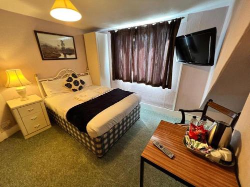 Tempat tidur dalam kamar di Belvedere Guest House, Great Yarmouth