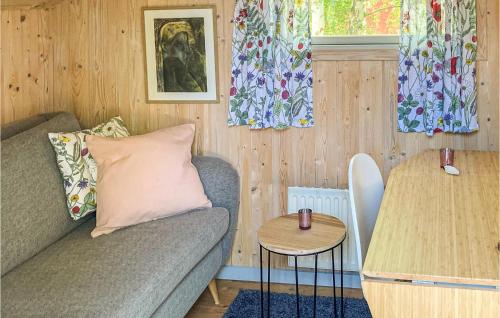 a living room with a couch and a table at Lovely Home In Heberg With Sauna in Heberg
