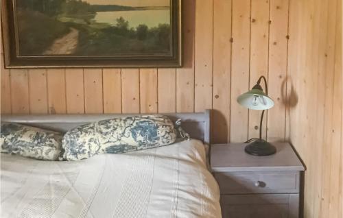 a bedroom with a bed and a picture on the wall at Lovely Home In Heberg With Sauna in Heberg