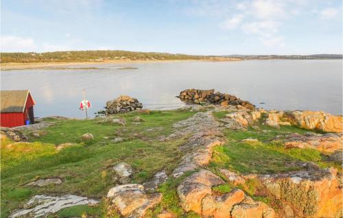 a red barn on the shore of a body of water at Lovely Home In Heberg With Sauna in Heberg
