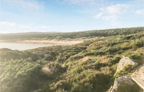 a view of a grassy hill with a beach at Lovely Home In Heberg With Sauna in Heberg