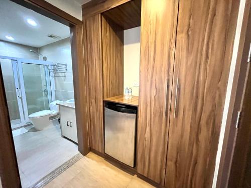 a bathroom with a sink and a washer and dryer at Leope Hotel in Cebu City