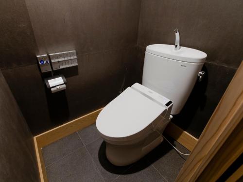 a bathroom with a white toilet in a stall at Hotel Gracery Kyoto Sanjo in Kyoto
