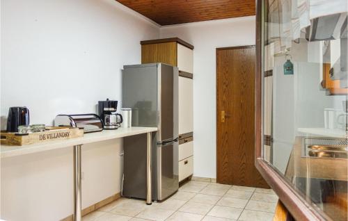 a kitchen with a stainless steel refrigerator and a counter at Awesome Apartment In Dillenburg in Dillenburg