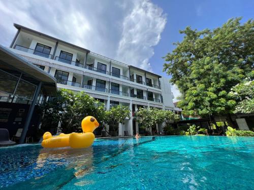 a rubber duck in a swimming pool in front of a building at Z&Z Resort in Rawai Beach