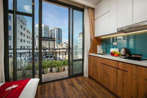 a kitchen with a view of a city skyline at Au Coeur d'Hanoi Apartment in Hanoi