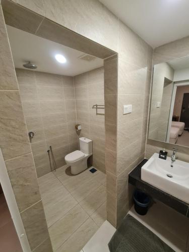 a bathroom with a toilet and a sink and a shower at Ants Hotel in Kangar