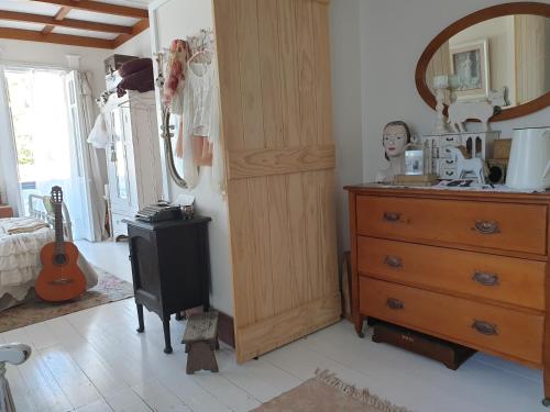 a bedroom with a dresser and a mirror and a drawer at Cabins on Tudor bed & breakfast in Motueka