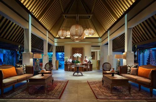 a lobby of a resort with couches and tables at Goya Boutique Resort in Ubud