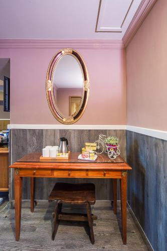 a wooden table with a mirror on a wall at 翠安儂風旅 in Taitung City