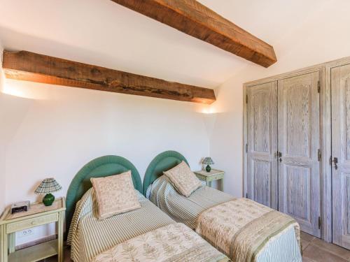 - 2 lits dans une chambre dotée de poutres en bois dans l'établissement Chateau in Lorgues with Pool & Vineyard Views, à Lorgues