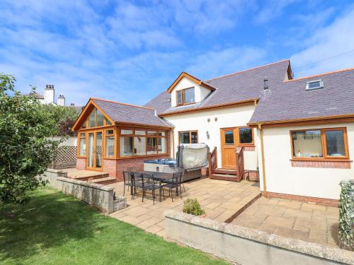 a house with a deck and a patio at Ger Y Mor in Cemaes Bay