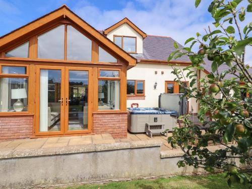 an extension to a house with sliding glass doors at Ger Y Mor in Cemaes Bay