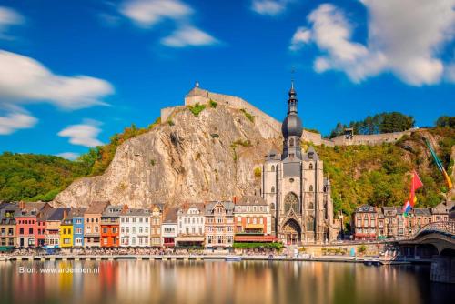 a town on the water in front of a mountain at Chalet Durbuy 123 in Durbuy