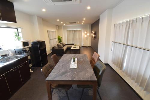 a living room with a table and a couch at Ogu house Beppu in Beppu